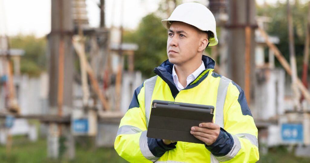 Commercial construction worksite with man wearing a yellow vest